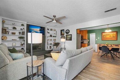 Living room with built in features, light hardwood