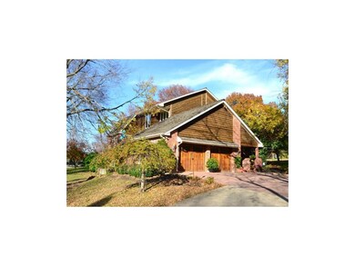 Side-entry garage doors and paver courtyard front 
