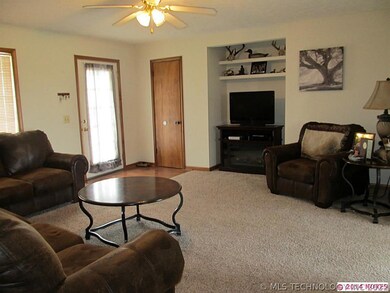 Clean living room with coat closet.