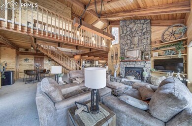Carpeted living area with wood walls, wood ceiling, a fireplace, beamed ceiling, and stairway