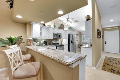 The eat-in kitchen provides ample dining seats with the table by the window and the breakfast bar.