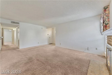 Unfurnished living room featuring a fireplace with