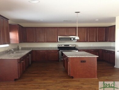 KITCHEN WITH GRANITE COUNTER TOPS LAMINATE WOOD FL