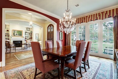 Formal dining room off entry offers sparkling hardwoods with stationary French doors with glass panels overlooking the courtyard. Off dining is a Butler's pantry/wet bar equipped with warming drawer, beverage fridge, sink with disposal, secondary dishwasher, perfect for large scale entertaining!