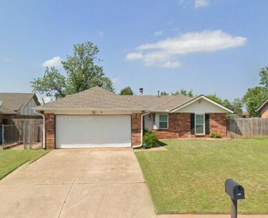 Ranch-style house with a garage and a front lawn