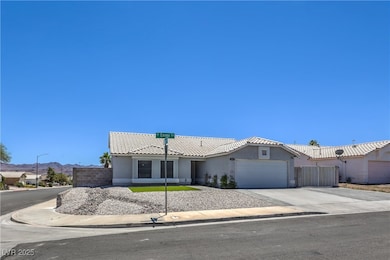 View of front facade featuring stucco siding, a ga