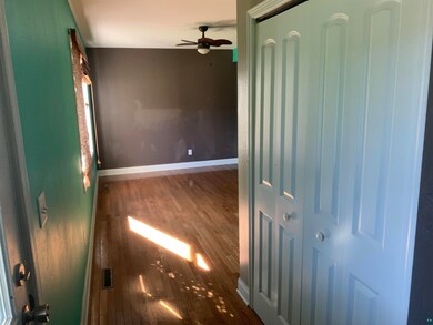 Empty room featuring dark hardwood / wood-style fl