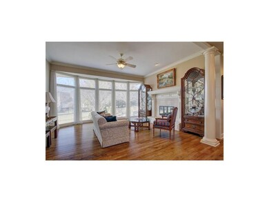 Great room w/ floor to ceiling windows & hardwood 
