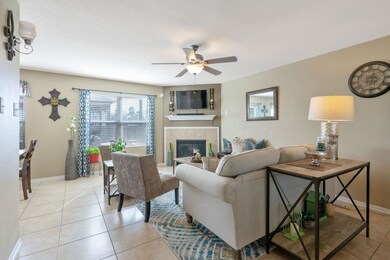 The living room has both a fireplace and a large window overlooking the back yard.