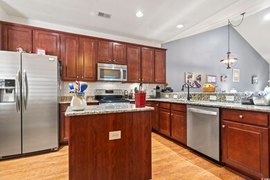Kitchen with backsplash, light stone counters, sta