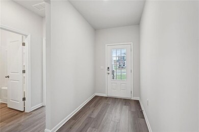 Doorway featuring visible vents, baseboards, and w