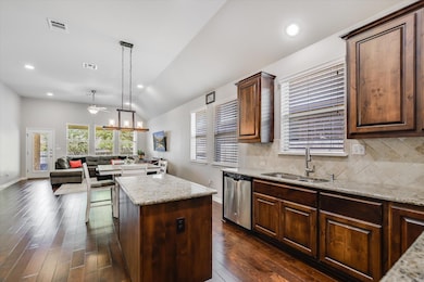 Kitchen with stainless steel dishwasher, a sink, 