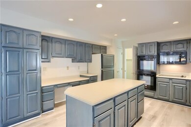 Endless counter space, cabinetry and double ovens provide the perfect kitchen for meal prep and clean up.