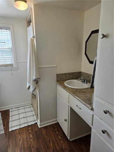 Bathroom featuring vanity, wood finished floors, a