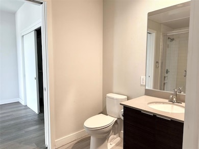 Full bath with vanity, wood finished floors, and 