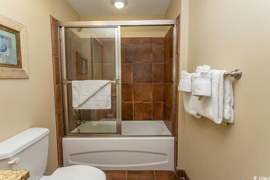 Bathroom featuring tile patterned floors, bath / s