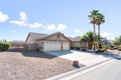 View of front of property featuring concrete driveway, an attached garage, stucco siding, a gate, and a tiled roof