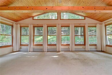 Sun room is surrounded by windows