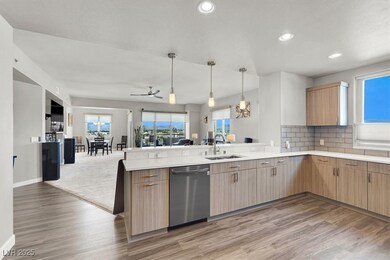 Kitchen with stainless steel dishwasher, open floor plan, a peninsula, light countertops, and recessed lighting
