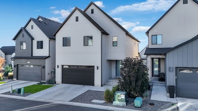 Modern farmhouse style home featuring concrete driveway, a garage, and roof with shingles