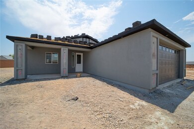 Back of property with a garage