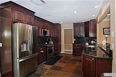 Beautiful kitchen with cherry custom cabinets, sta