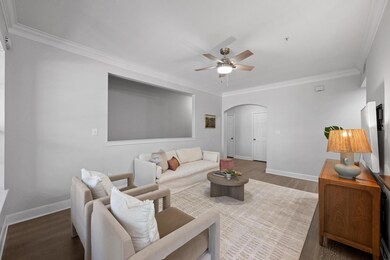 Living area featuring baseboards, ornamental mold