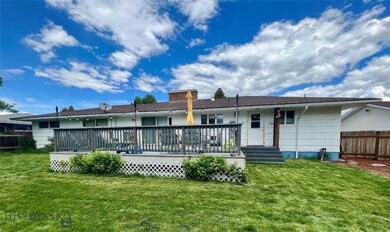 Large fenced backyard with mature landscaping and