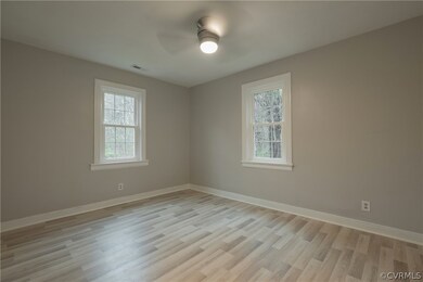 Unfurnished room with ceiling fan and light hardwo