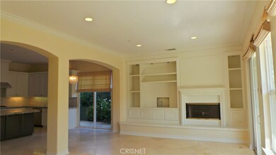 Attached open family room has slider door to covered patio with BBQ center and pool/spa