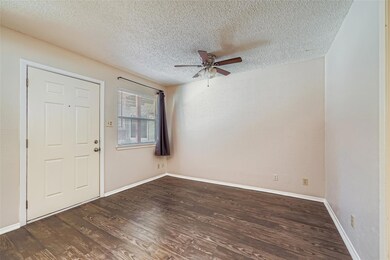 Entrance foyer with wood finished floors, a textured ceiling, and ceiling fan
