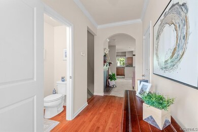 Entryway featuring ornamental molding and light pa