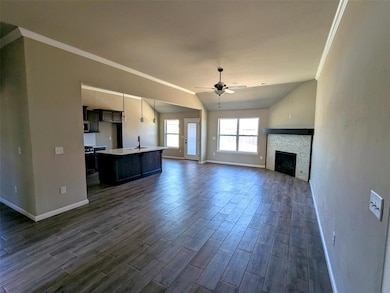 Unfurnished living room with crown molding, a fire