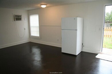 Kitchen featuring freestanding refrigerator, baseb