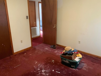 Unfurnished bedroom with baseboards and carpet flooring