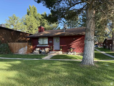 View of front of house featuring a chimney and a front yard