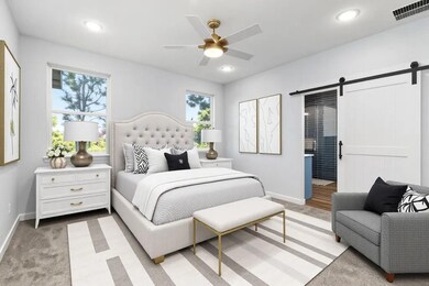 Bedroom featuring a barn door, baseboards, and re