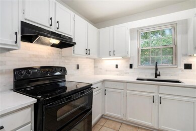 Kitchen with under cabinet range hood, white cabin