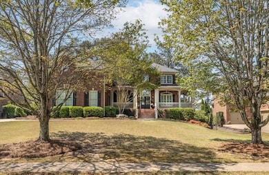 View of front facade featuring a front lawn, brick