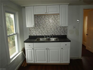Upper unit --newer cabinets, sink, counter top, an