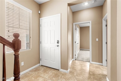 Entrance foyer featuring light tile patterned floo
