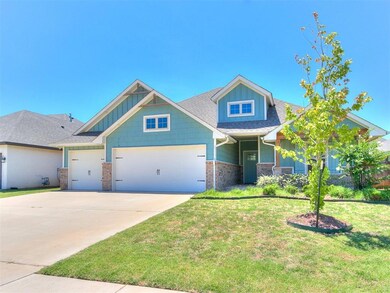 Craftsman house with a garage and a front yard