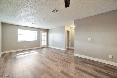 Unfurnished room featuring visible vents, light wo