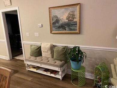 Sitting room featuring baseboards and wood finished floors