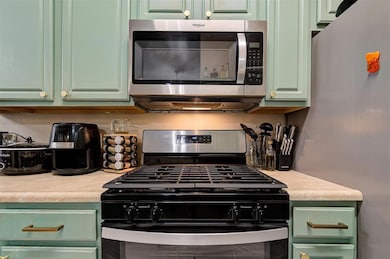 Kitchen with stainless steel appliances, light cou