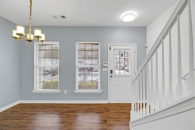 Foyer entrance with stairs, an inviting chandelier