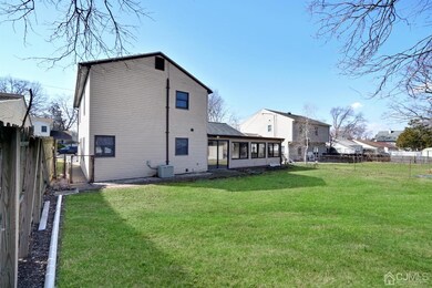 Exterior back featuring large fenced in backyard.