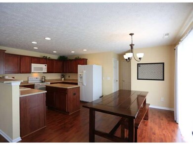 Breakfast Area/Room. Another view of the spacious kitchen, leading into the breakfast area.