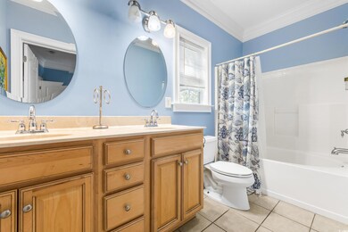 Full bathroom featuring ornamental molding, vanity