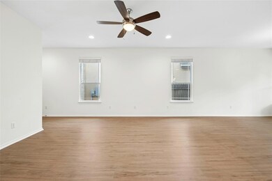 Spare room featuring light wood-style flooring, b